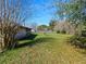 Spacious backyard featuring a well-maintained lawn, mature trees, and a privacy fence at 794 Elwood St, Deltona, FL 32725