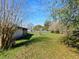 Large, grassy backyard with mature trees and a fence at 794 Elwood St, Deltona, FL 32725