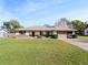 Single story home with a charming brick accent and a well-maintained lawn on a sunny day at 794 Elwood St, Deltona, FL 32725