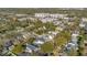 Aerial view of a neighborhood showcasing tree-lined streets, homes, and local businesses nearby at 831 W Harvard St, Orlando, FL 32804