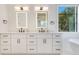 Bathroom featuring double sinks, modern fixtures, a soaking tub, and natural lighting through a window at 831 W Harvard St, Orlando, FL 32804