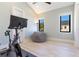 Neutral bedroom with a Peloton bike, beanbag chair, and two large windows for natural light at 831 W Harvard St, Orlando, FL 32804