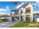 Beautiful two-story home with stone accents, modern garage door and balcony at 831 W Harvard St, Orlando, FL 32804