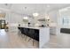 Open kitchen featuring a large island with seating, stainless steel appliances, and white cabinetry at 831 W Harvard St, Orlando, FL 32804