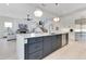 Contemporary kitchen with gray island, white countertops, stainless steel appliances, and open flow to the living area at 831 W Harvard St, Orlando, FL 32804