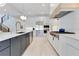 A modern, open kitchen featuring white cabinetry, stainless steel appliances and a large island with seating at 831 W Harvard St, Orlando, FL 32804