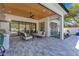 Inviting outdoor living space with a ceiling fan, an outdoor kitchen, and large sliding glass doors at 831 W Harvard St, Orlando, FL 32804