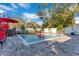 Outdoor pool area featuring mature landscaping, seating area, and a red umbrella, perfect for summer gatherings at 831 W Harvard St, Orlando, FL 32804