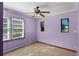 Cozy bedroom featuring a ceiling fan, two windows, and pastel-colored walls at 866 Gatlin Ave, Orlando, FL 32806