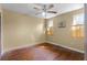 A bedroom with hardwood floors, two windows, and a ceiling fan at 866 Gatlin Ave, Orlando, FL 32806