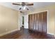 Bedroom featuring hardwood floors, a closet, and a ceiling fan at 866 Gatlin Ave, Orlando, FL 32806