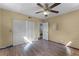 A bedroom featuring wood-look floors, a closet, and a ceiling fan at 866 Gatlin Ave, Orlando, FL 32806