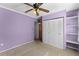 A modest bedroom showcasing a closet with bi-fold doors and a ceiling fan at 866 Gatlin Ave, Orlando, FL 32806