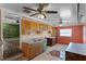 A dated kitchen featuring paneled walls, vintage cabinets, and tiled floors in need of remodeling at 866 Gatlin Ave, Orlando, FL 32806