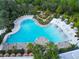 Aerial view of the community pool featuring a mini golf course and many lounge chairs at 929 Conch Rd, Davenport, FL 33896