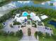 Aerial view of community clubhouse and resort-style pool with lake backdrop and ample parking at 929 Conch Rd, Davenport, FL 33896