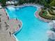 Overhead view of community pool showcasing ample lounge seating and a mini golf course at 929 Conch Rd, Davenport, FL 33896