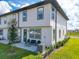 Townhome backyard featuring a patio, green lawn, and well maintained landscaping at 929 Conch Rd, Davenport, FL 33896