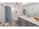 Neat bathroom featuring a vanity with quartz countertops and a shower-tub combo at 929 Conch Rd, Davenport, FL 33896