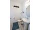 Chic powder room featuring a pedestal sink, toilet, and stylish decor with gray tiling at 929 Conch Rd, Davenport, FL 33896