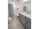 Bathroom with single sink vanity, white countertops, and a shower-tub combination at 929 Conch Rd, Davenport, FL 33896