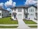 Charming two-story townhome with lush lawn, one-car garage, and inviting curb appeal at 929 Conch Rd, Davenport, FL 33896