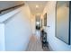 Bright foyer and hallway with light-wood tile, white walls, and stairwell at 929 Conch Rd, Davenport, FL 33896