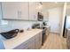 Bright kitchen with stainless steel appliances, gray cabinets, and quartz countertops at 929 Conch Rd, Davenport, FL 33896