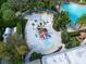 Aerial view of pirate-themed splash pad with small slide and beach-entry pool in a gated community at 929 Conch Rd, Davenport, FL 33896