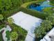 Aerial view of a sand volleyball court adjacent to a pond and mini golf course at 929 Conch Rd, Davenport, FL 33896