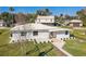 Aerial view of a house with a well-manicured lawn, fresh paint, and new landscaping at 9400 Ne 307Th Ct, Fort Mc Coy, FL 32134