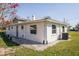 Rear exterior view of house, showcasing the roofline, yard, and siding details at 9400 Ne 307Th Ct, Fort Mc Coy, FL 32134