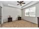 Main bedroom featuring carpet, ceiling fan, and window with blinds at 9472 Sw 76Th St, Ocala, FL 34481