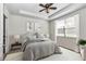 Neutral bedroom featuring a tray ceiling, ceiling fan, and bright window view at 9472 Sw 76Th St, Ocala, FL 34481