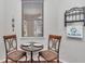 Intimate breakfast nook showcasing a decorative window and elegant furnishings at 9472 Sw 76Th St, Ocala, FL 34481