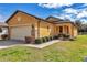 Charming home with a well-manicured lawn and stone accents on the garage and front columns at 9472 Sw 76Th St, Ocala, FL 34481