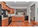 Well-lit kitchen with stainless steel appliances, granite countertops, and wooden cabinetry at 9472 Sw 76Th St, Ocala, FL 34481