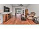 Bright living room featuring hardwood floors and a ceiling fan overlooking a covered outdoor patio at 9472 Sw 76Th St, Ocala, FL 34481