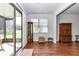 Living room featuring hardwood floors, a cabinet, and large sliding door at 9472 Sw 76Th St, Ocala, FL 34481