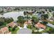 Lakeside home aerial view shows its proximity to community, mature landscaping and water views at 100 Honeywood Ct, Kissimmee, FL 34743