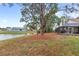 The backyard slopes gently towards the pond, offering serene views and a natural landscape at 100 Honeywood Ct, Kissimmee, FL 34743