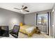 Bedroom with gray walls, tile floor, ceiling fan, desk, and view of pond at 100 Honeywood Ct, Kissimmee, FL 34743