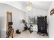 Bright home gym features exercise equipment and natural light from a large window at 100 Honeywood Ct, Kissimmee, FL 34743