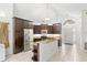 Bright kitchen with dark wood cabinetry and stainless steel appliances at 100 Honeywood Ct, Kissimmee, FL 34743