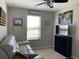 Cozy bedroom with a ceiling fan, a window, and a comfortable couch at 1013 Flowing Tide Dr, Orlando, FL 32828