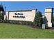 Towns at Avalon Ridge community entrance sign with manicured landscaping and clear blue sky at 1013 Flowing Tide Dr, Orlando, FL 32828