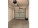 Clean, empty single-car garage with white walls and a functional overhead door at 1013 Flowing Tide Dr, Orlando, FL 32828