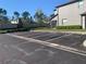 Exterior view of a parking lot with dedicated parking spots and green landscaping around the building at 1013 Flowing Tide Dr, Orlando, FL 32828