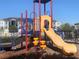 Community playground with colorful play structure including slide, steps, and climbing features at 1013 Flowing Tide Dr, Orlando, FL 32828