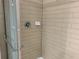 Tiled shower stall with glass door, modern fixtures, and a built-in soap dish at 1013 Flowing Tide Dr, Orlando, FL 32828